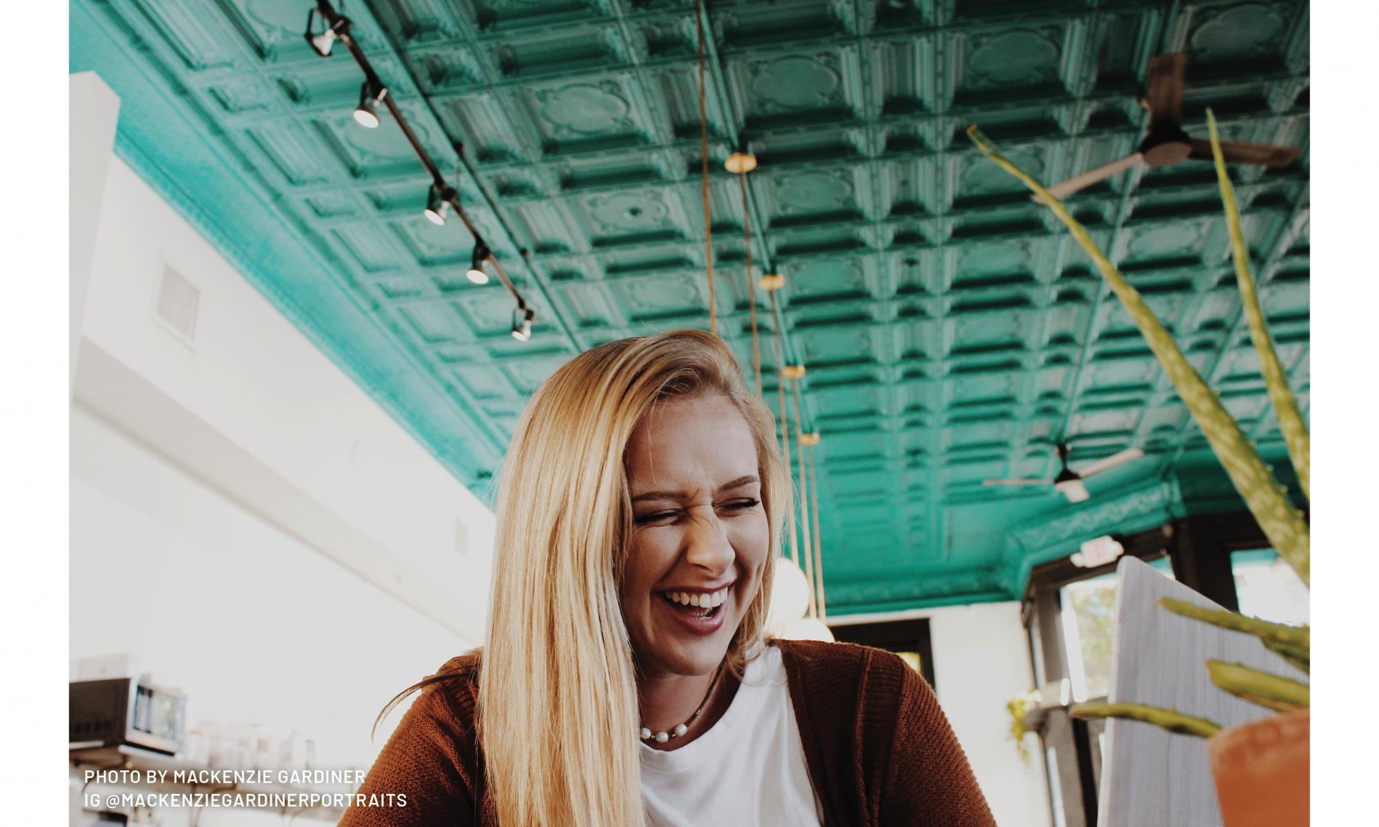 girl smiling at leslie coffee co in delano, downtown wichita, kansas