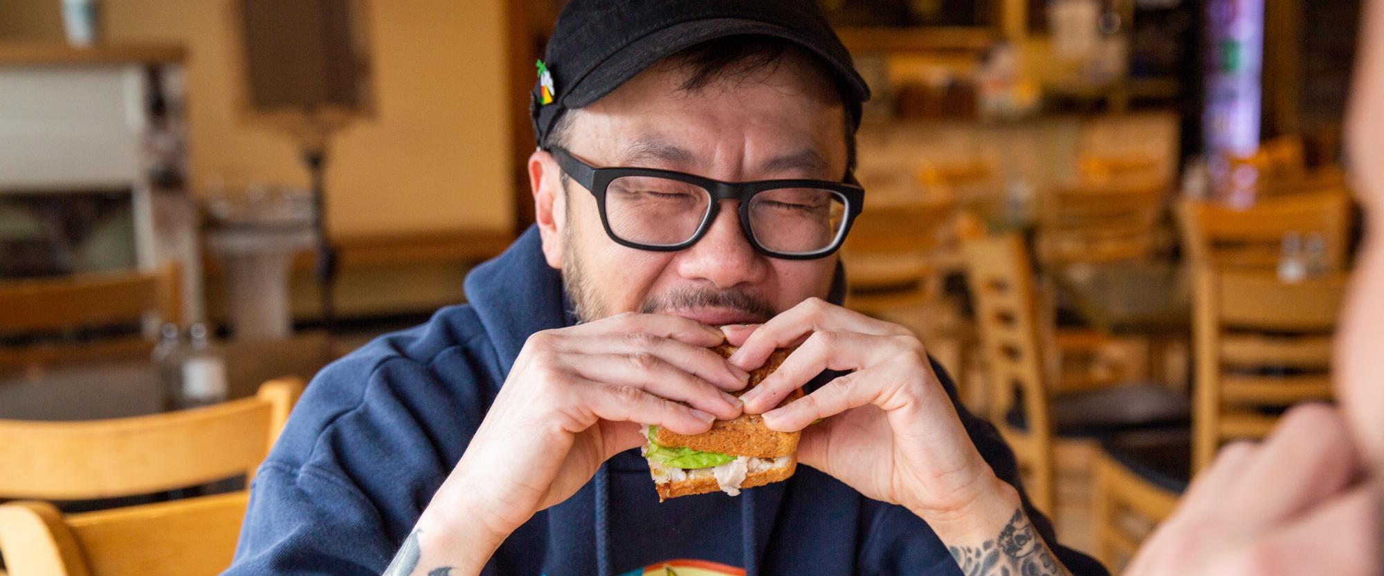 man enjoying a sandwich at tanya's soup kitchen in wichita, kansas